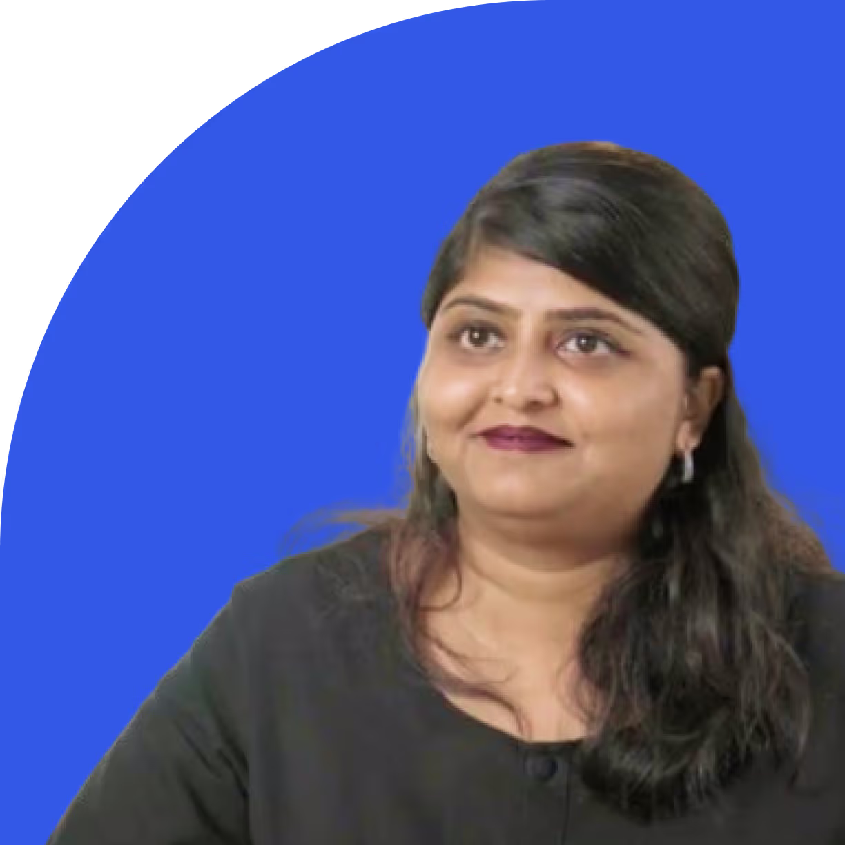 Woman with long dark hair wearing a black top, smiling against a blue background.